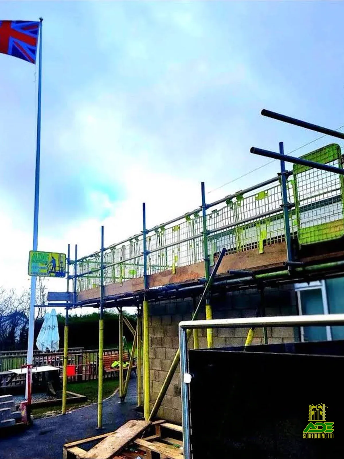 Scaffold platform with UK flag and ADE signage on site