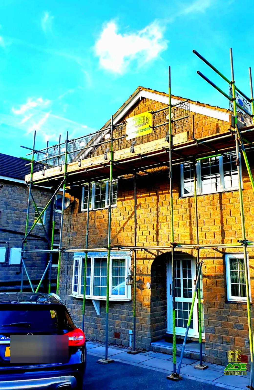 Full-height gable scaffold with apex access on a stone semi